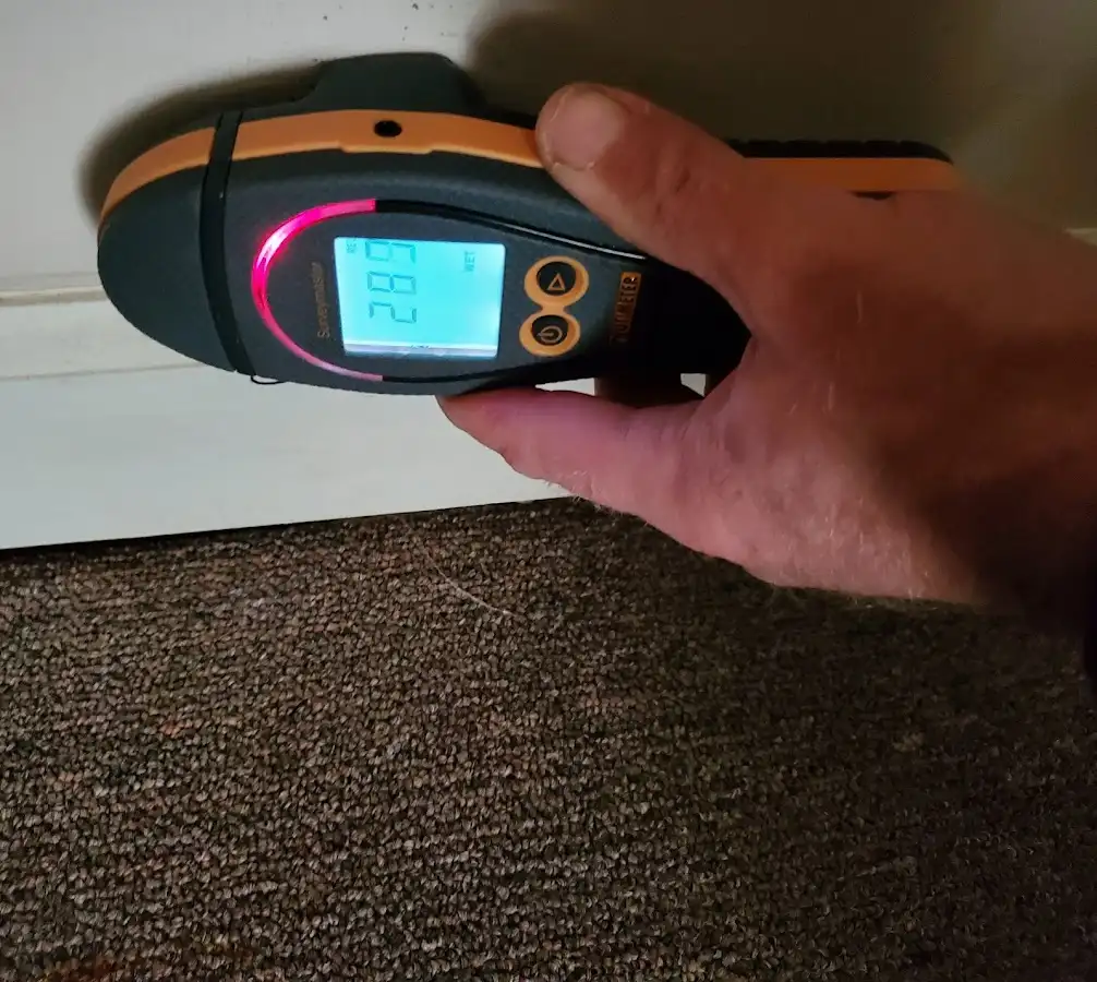 Moisture detection at baseboard during Storm Damage Restoration in Raymondville
